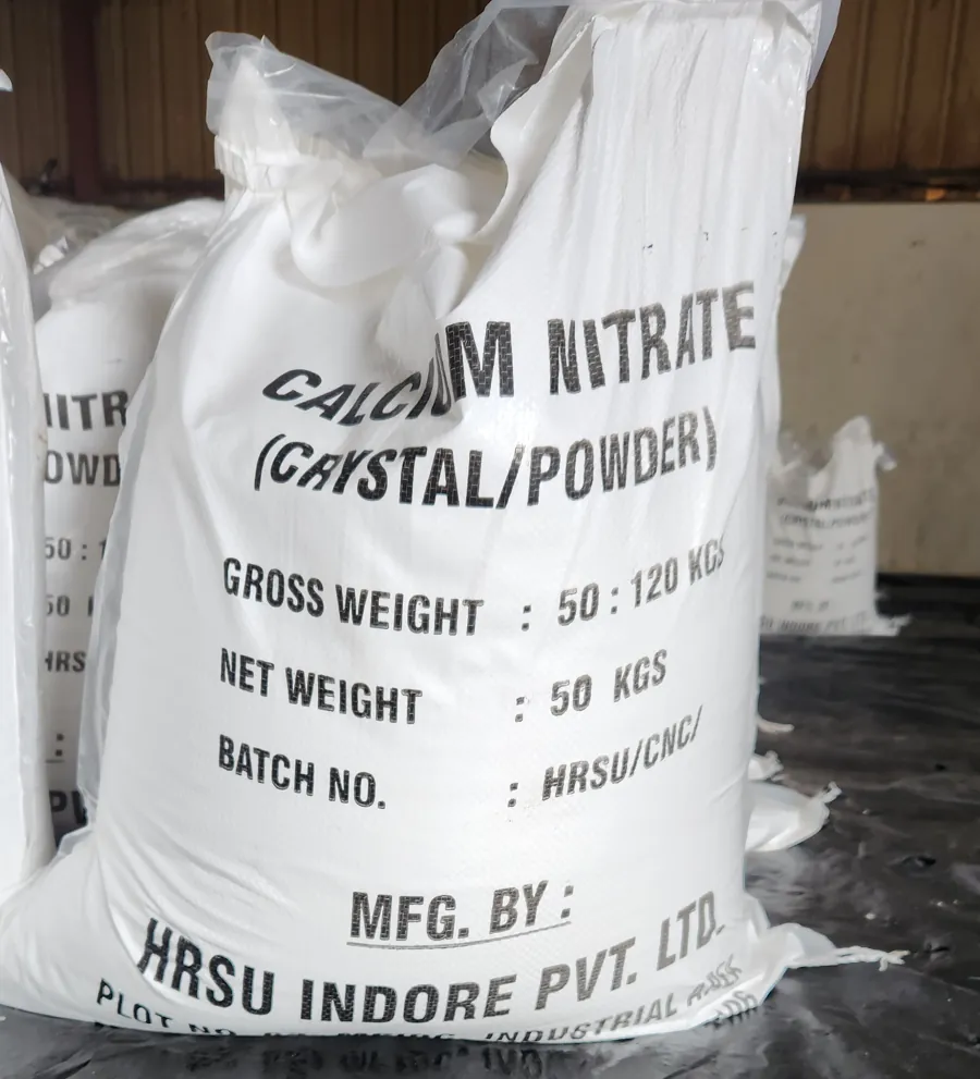 A 50 kg white woven bag of calcium nitrate marked HRSU Indore Pvt. Ltd., Plot No. 62, MPIDC Industrial Area, Maksi, standing in the plant store